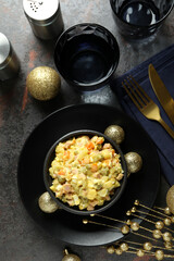 Christmas concept of tasty food with Olivier salad on dark background