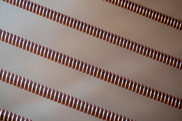 A close-up of strings of a grand piano that looks abstract