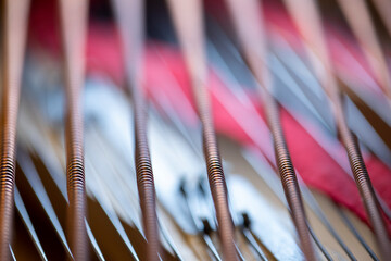 A close-up of strings of a grand piano that looks abstract