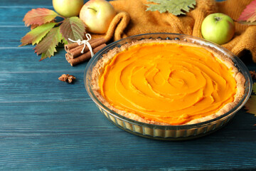 Concept of tasty food with pumpkin pie on wooden background