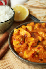 Concept of tasty food with chicken tikka on wooden background