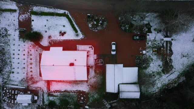Heat loss concept, energy leaking out from a snowy detached house - 3d animation