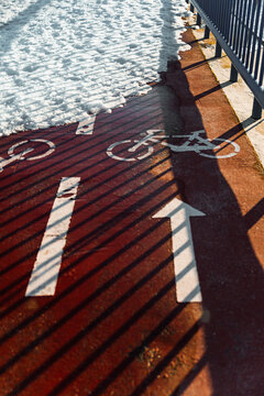 Bicycle lane on snowy fenced road