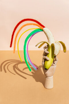 Peeled banana with colored splashes