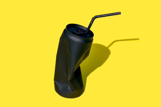 Black crumpled jar with straw