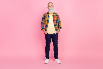 Photo of pretty attractive age gentleman wear plaid shirt spectacles arms pockets smiling isolated...