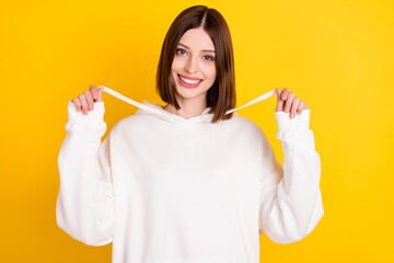 Photo of positive lovely pretty lady shiny smile wear white sweatshirt isolated yellow color background