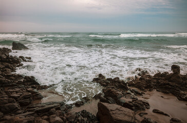 Landscape of rock on beach on a windy day