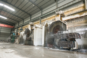 Big industrial machine cutting stone in a factory
