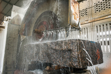 Big industrial machine cutting stone in a factory