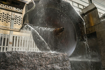 Big industrial machine cutting stone in a factory