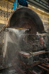 Big industrial machine cutting stone in a factory