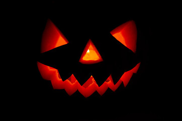 scary smiling glowing pumpkin lantern for halloween in the dark