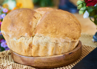 Home made baked bread on wooden dish 