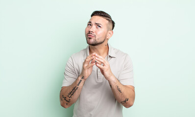 young handsome man scheming and conspiring, thinking devious tricks and cheats, cunning and...