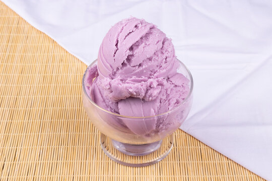 Tasty Grape-flavored purple ice cream served in the bowl. towel crumpled diagonally across the bottom. Image Gourmet ice cream shop.