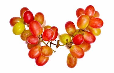 Beautiful red and green bunch of sweet red grapes on white background.
