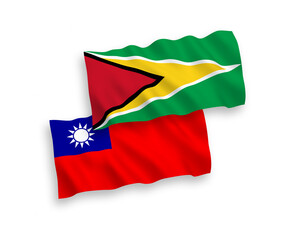 National vector fabric wave flags of Co-operative Republic of Guyana and Taiwan isolated on white background. 1 to 2 proportion.