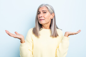 middle age gray hair woman looking puzzled, confused and stressed, wondering between different...