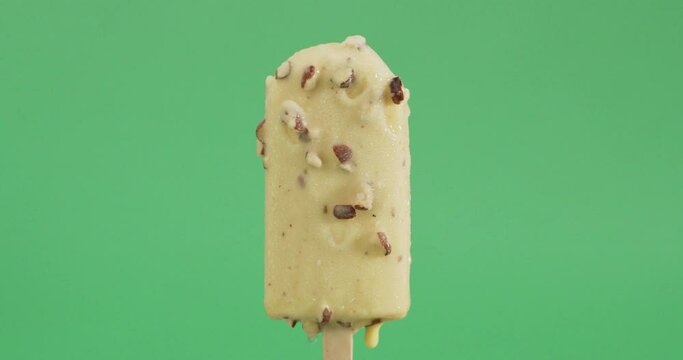ice cream popsicle sticks isolated on a green background.