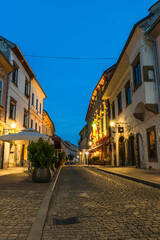 Fototapeta na wymiar Ptuj Illuminated Coble Street in Slovenia at Blue Hour