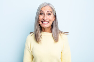 middle age gray hair woman looking happy and goofy with a broad, fun, loony smile and eyes wide open - obrazy, fototapety, plakaty