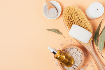 Organic oil with natural bathroom supplies on beige background