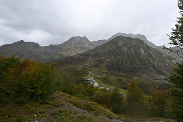 house in the distance, Mountain road, mountains in the clouds