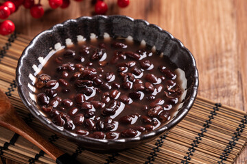 Adzuki red bean soup on wooden table background.