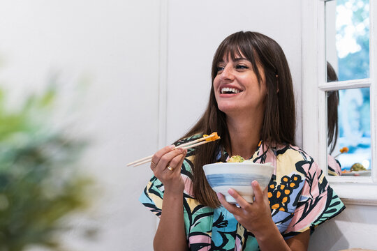 Happy woman having food at restaurant