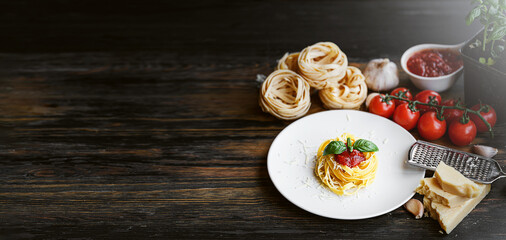 italian pasta bolognese with grated parmesan and basil close-up ingredients in the background