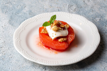 Traditional Turkish style quince dessert. The quince is cooked until soft, sherbet is poured on it, and served with cream and walnuts. It is one of the most popular Turkish desserts.(Ayva Tatlisi)