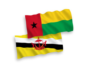 National vector fabric wave flags of Republic of Guinea Bissau and Brunei isolated on white background. 1 to 2 proportion.