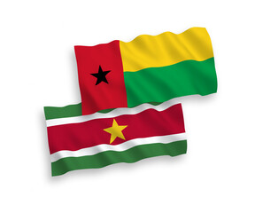 National vector fabric wave flags of Republic of Guinea Bissau and Republic of Suriname isolated on white background. 1 to 2 proportion.