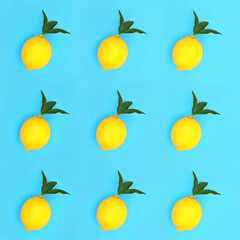 Lemon fruit with green leaf sprigs. Minimal design concept for low cholesterol, extreme diet and weight loss. High in antioxidants and vitamin c. Isometric pattern on blue background.