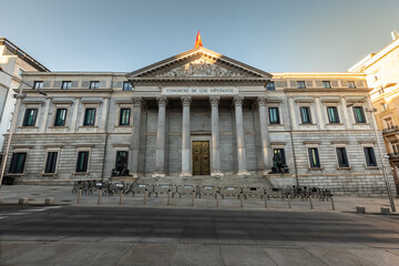 Fototapeta na wymiar Spanish parliament (Congreso de los diputados) famous facade with two lions sculptures at each side; Madrid, Spain.