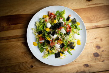 Delicious rice salad with lettuce, tomato, escarole and seaweed. Gourmet salad with natural products.