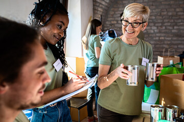 Group of volunteers working in community charity donation center.	