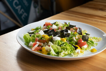 Delicious rice salad with lettuce, tomato, escarole and seaweed. Gourmet salad with natural products.