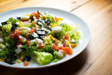 Delicious rice salad with lettuce, tomato, escarole and seaweed. Gourmet salad with natural products.