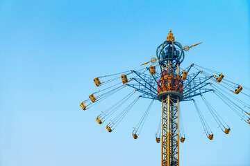 The rotating flying chair is in the amusement park