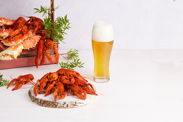 A glass of light beer with boiled crayfish and crabs.