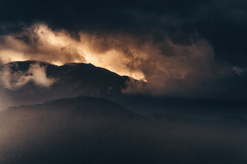 Beautiful sunset over the mountains with a lot of clouds