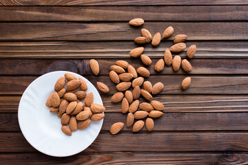 almonds in a bowl on a wooden background
