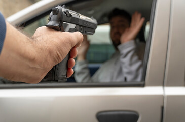 Man is robbed in a car. Concept of lack of road safety.