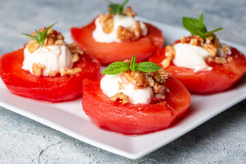 Traditional Turkish style quince dessert. The quince is cooked until soft, sherbet is poured on it, and served with cream and walnuts. It is one of the most popular Turkish desserts.(Ayva Tatlisi)