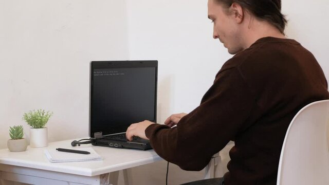 The man smashed laptop with hammer. Error, does not turn on, system crash. person is upset tired stressed, depressed, sad, angry psycho. Broke computer, destroyed, crazy. office worker. unbearably