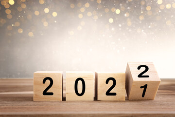 wooden cubes with the text 2022 over bright shiny background