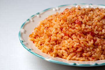 Traditional turkish bulgur pilaf with tomato sause in plate (Turkish name; meyhane pilavi)