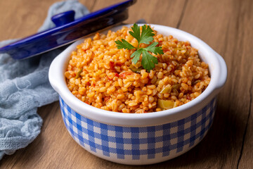 Traditional turkish bulgur pilaf with tomato sause in plate (Turkish name; meyhane pilavi)